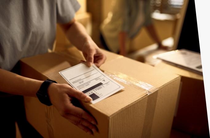 Person preparing a shipping label for a Priority Mail box.